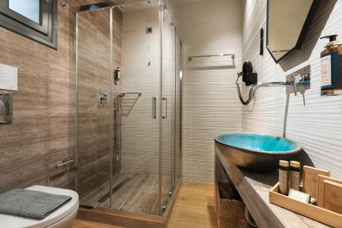 a bathroom with a tub and a shower at Carpe Diem Boutique Hotel in Nafplio