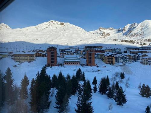 a resort in the snow with a mountain in the background at Cervus in Passo del Tonale