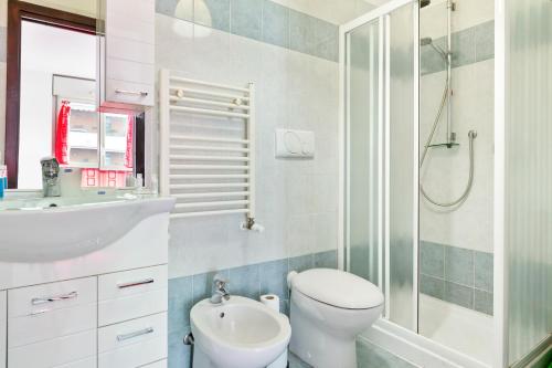 a bathroom with a shower and a toilet and a sink at Milano-Rubattino Budget Apartment in Milan