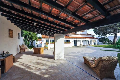 an outdoor patio with a wooden pergola at Santo António's Guesthouse in Cascais