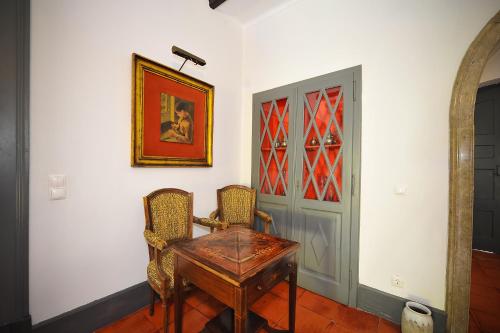a dining room with a table and two chairs at Santo António's Guesthouse in Cascais
