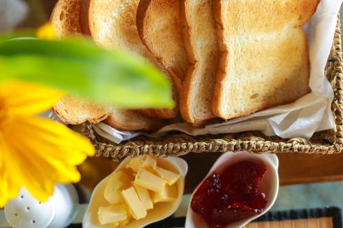 a sandwich with cheese and butter on a plate at Mount Marina Villas 12 in Galle