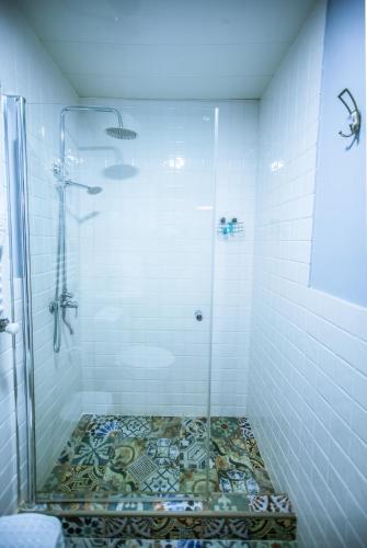 a bathroom with a shower with a mosaic floor at Home 12 in Tbilisi City