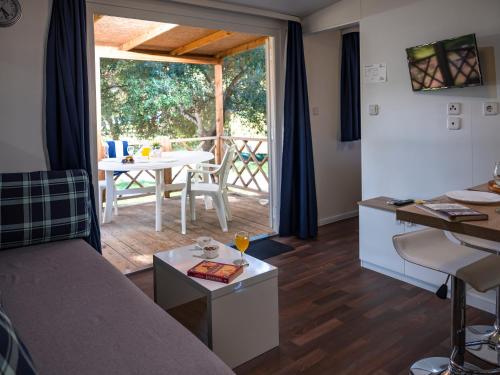 a living room with a couch and a table at Mobile Homes Camp Pineta - Adriatic Kampovi in Fažana