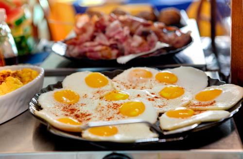 a plate of eggs on a table with other foods at Hotel Napoleon in Lido di Jesolo