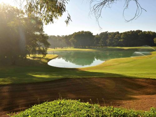 a view of a golf course with a pond at Pullman Mazagan Royal Golf & Spa in El Jadida