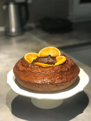 a cake with oranges on top of it on a plate at B&Benny in Reggio Calabria
