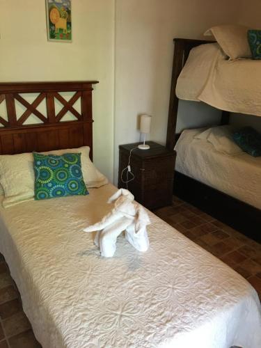 a bedroom with a bed with a robe on it at Cabaña del Pedemonte in Ciudad Lujan de Cuyo