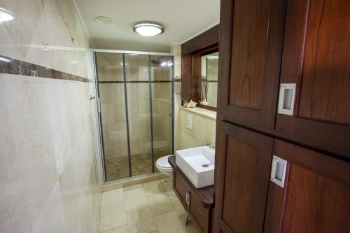 a bathroom with a toilet and a sink and a shower at Seaside Apartment Seastar in Kralendijk