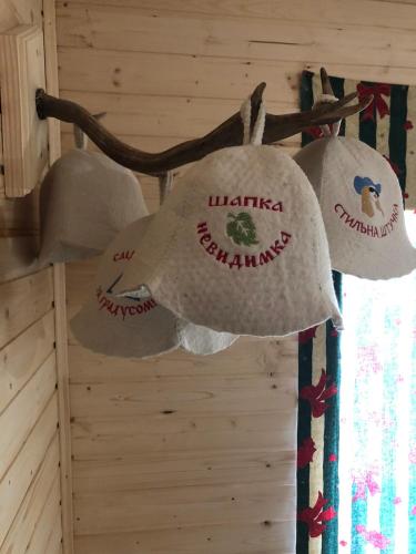 a group of hats hanging from the wall of a cabin at AGORA Chalet in Slavske