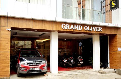 a small car parked in front of a garage at Grand Oliver in Chennai