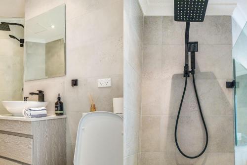 a bathroom with a shower with a toilet and a sink at Oh My Beach View - Penthouse Paradise in Sydney
