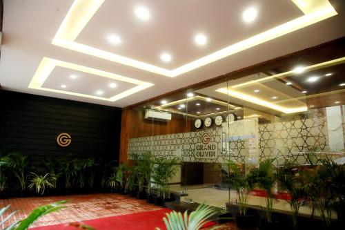 a lobby with potted plants in a building at Grand Oliver in Chennai