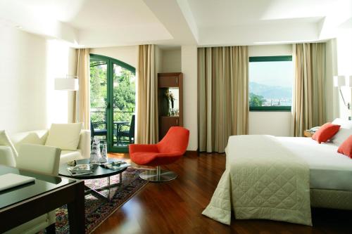 a bedroom with a bed and a living room at Hotel Raito Wellness & SPA in Vietri sul Mare