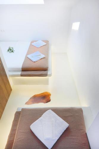 a room with two shelves with towels and a bed at Ariadni Villa Sani in Sani Beach