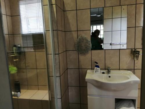 a bathroom with a sink and a mirror at Eden Cottage in White River