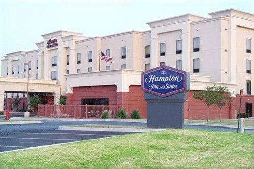 a sign in front of a large building at Hampton Inn & Suites Lawton in Lawton