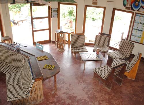 a living room with chairs and a table at Mambo View Point in Ndungu