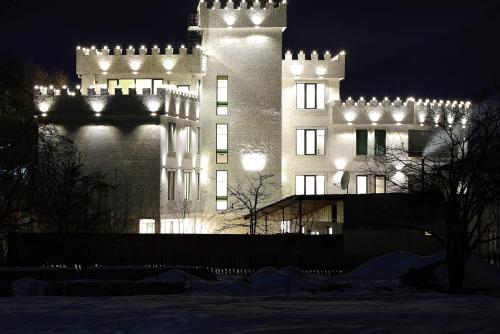 a large building with lights on it at night at Sunset Terrace Mestia in Mestia