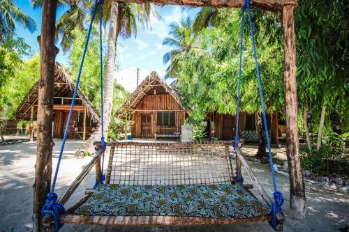 a swing in front of a house at Your Zanzibar Place in Paje