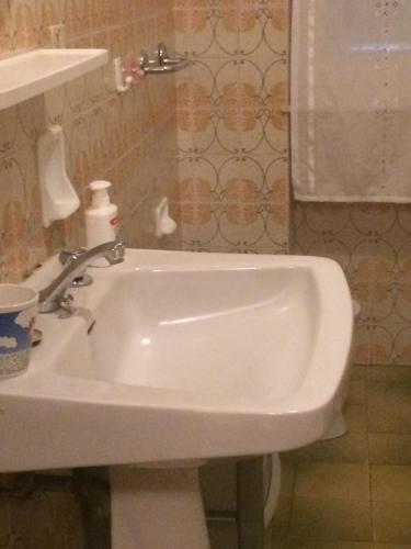 biała umywalka w łazience z lustrem w obiekcie Casa del mare Ligure Borgio Verezzi w mieście Borgio Verezzi