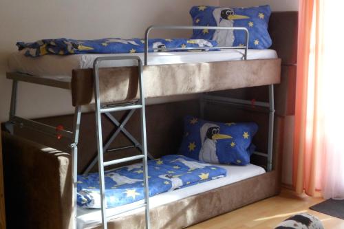 two bunk beds with penguins on them in a room at Berggasthaus Kraxenberger in Brannenburg