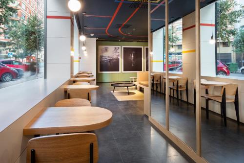 a row of tables and chairs in a restaurant at B&B HOTEL Castellón in Castellón de la Plana