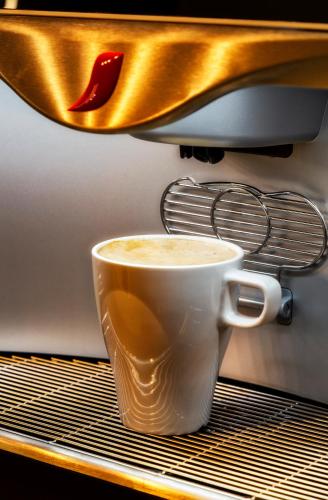 a cup of coffee sitting on a shelf at B&B HOTEL Castellón in Castellón de la Plana