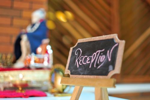 a wooden chair with a sign that says kelectronics at Mayur Hotel Bar And Restaurant in Solan