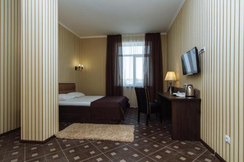 Een bed of bedden in een kamer bij Congress Hotel Verhovina