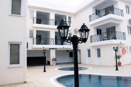 a street light in front of a building with a swimming pool at Carisa Livadia Gardens in Livadhia