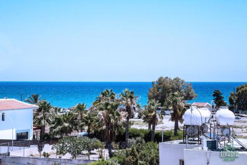 a view of the beach from the balcony of a resort at Carisa Livadia Gardens in Livadhia