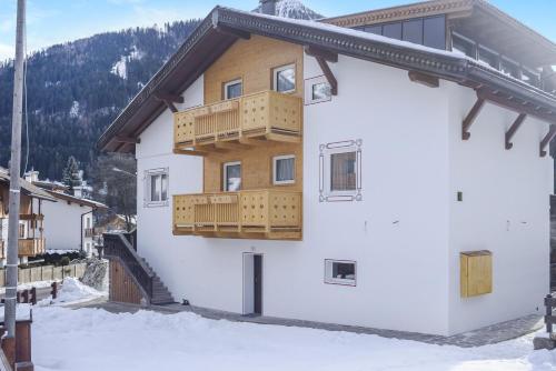 a building with wooden balconies on the side of it at Ciasa Christina - Attic in Moena