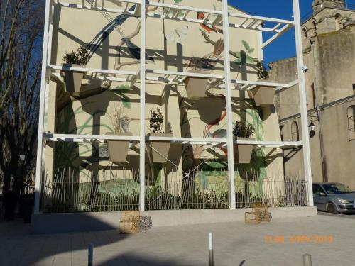 a building with a painting on the side of it at JOHA DOMA in Lunel