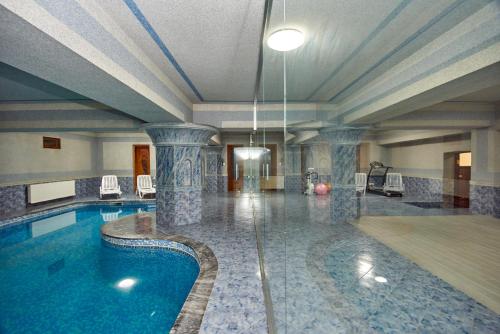 a swimming pool in a building with a pool at S&L Boutique Hotel in Tbilisi City