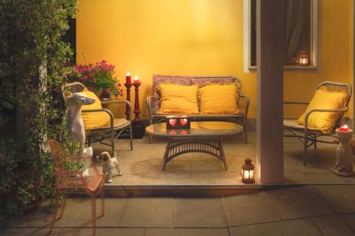a living room with a couch and a table and chairs at La Casa di Tina in Favaro Veneto