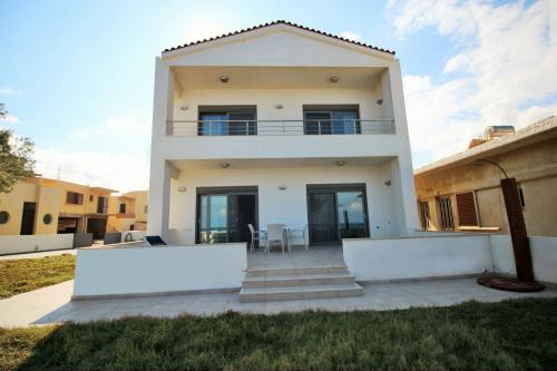 a villa with a view of a house at Amoutsa Seaside Villa in Kolymvari