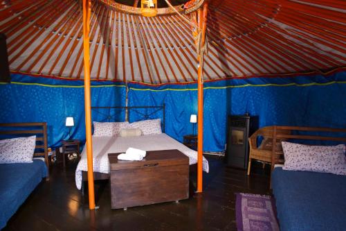 a bedroom with a bed in a blue tent at Società Agricola Cacigolara in Borgo Val di Taro