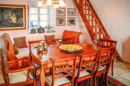a dining room with a wooden table and chairs at Villa Spetses in Spetses