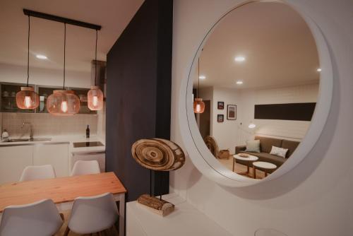 a living room with a table and a mirror at La Pardela Experience Apartamentos in Caleta de Sebo