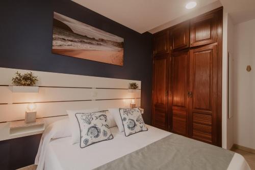 Cama o camas de una habitación en La Pardela Experience Apartamentos