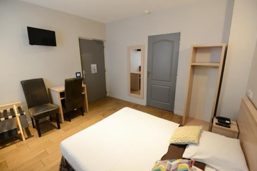 a bedroom with a bed and a desk and a table at LAFAYETTE HOTEL in Paris
