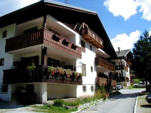 a white building with balconies and flowers on it at Solaia in Mazzin