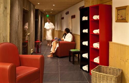 two people sitting in a chair in a room at Hotel le Petit Dru in Morzine