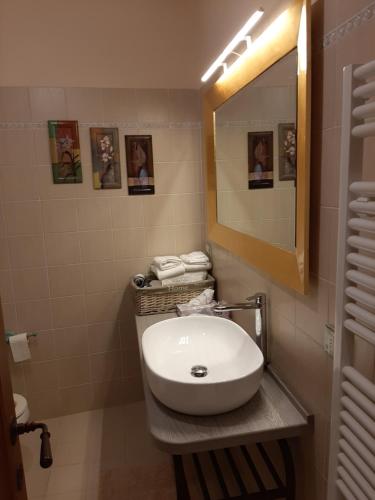 a white toilet sitting in a bathroom next to a sink at B&B Il Vecchietta in Castiglione dʼOrcia