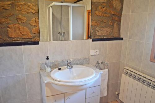 a bathroom with a sink and a mirror at Masoveria la Roca in Sagás