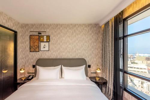 a bedroom with a bed and a large window at Radisson Blu Hotel Casablanca City Center in Casablanca