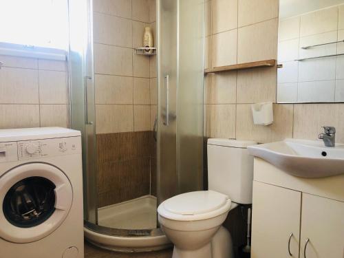a small bathroom with a toilet and a sink at White Arches Modern Beautiful studio in Limassol