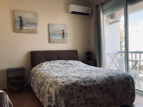a bedroom with a bed and a window at White Arches Modern Beautiful studio in Limassol