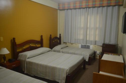 Un pat sau paturi într-o cameră la Hotel Obino São Borja
